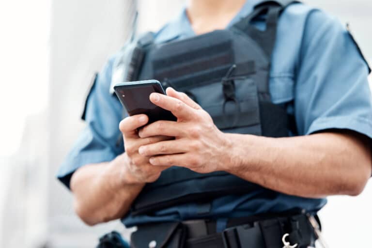 police officer with hands on phone
